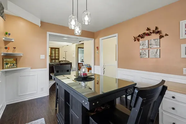 a view of a dining room with furniture and wooden floor