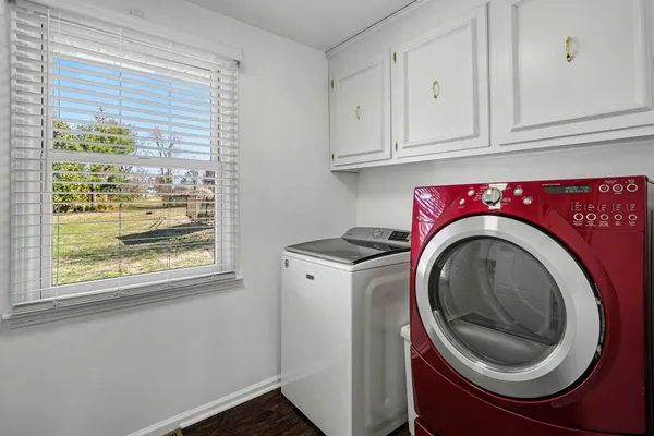 a utility room with sink dryer and washer