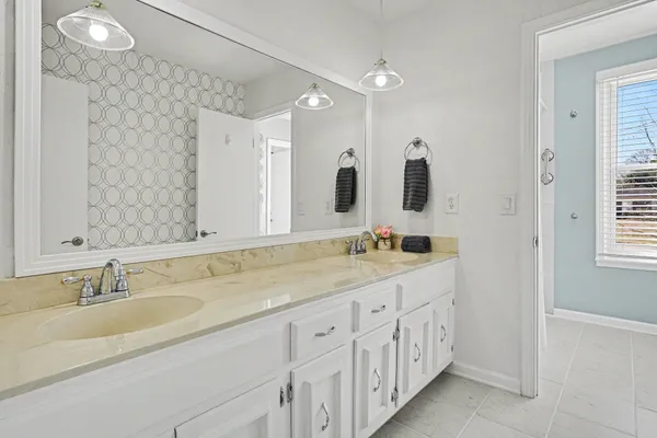 a bathroom with a double vanity sink and mirror