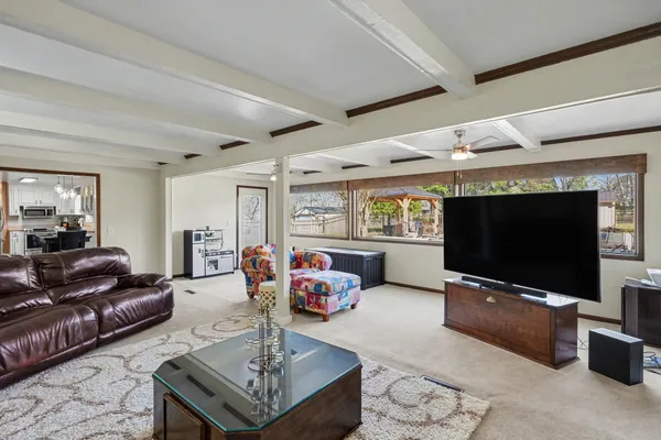 a living room with furniture a flat screen tv and a fireplace