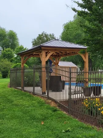 a view of backyard with swimming pool