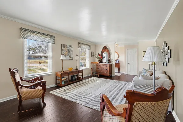 a bedroom with furniture and a wooden floor