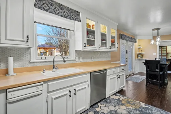 a kitchen with stainless steel appliances granite countertop a sink and cabinets