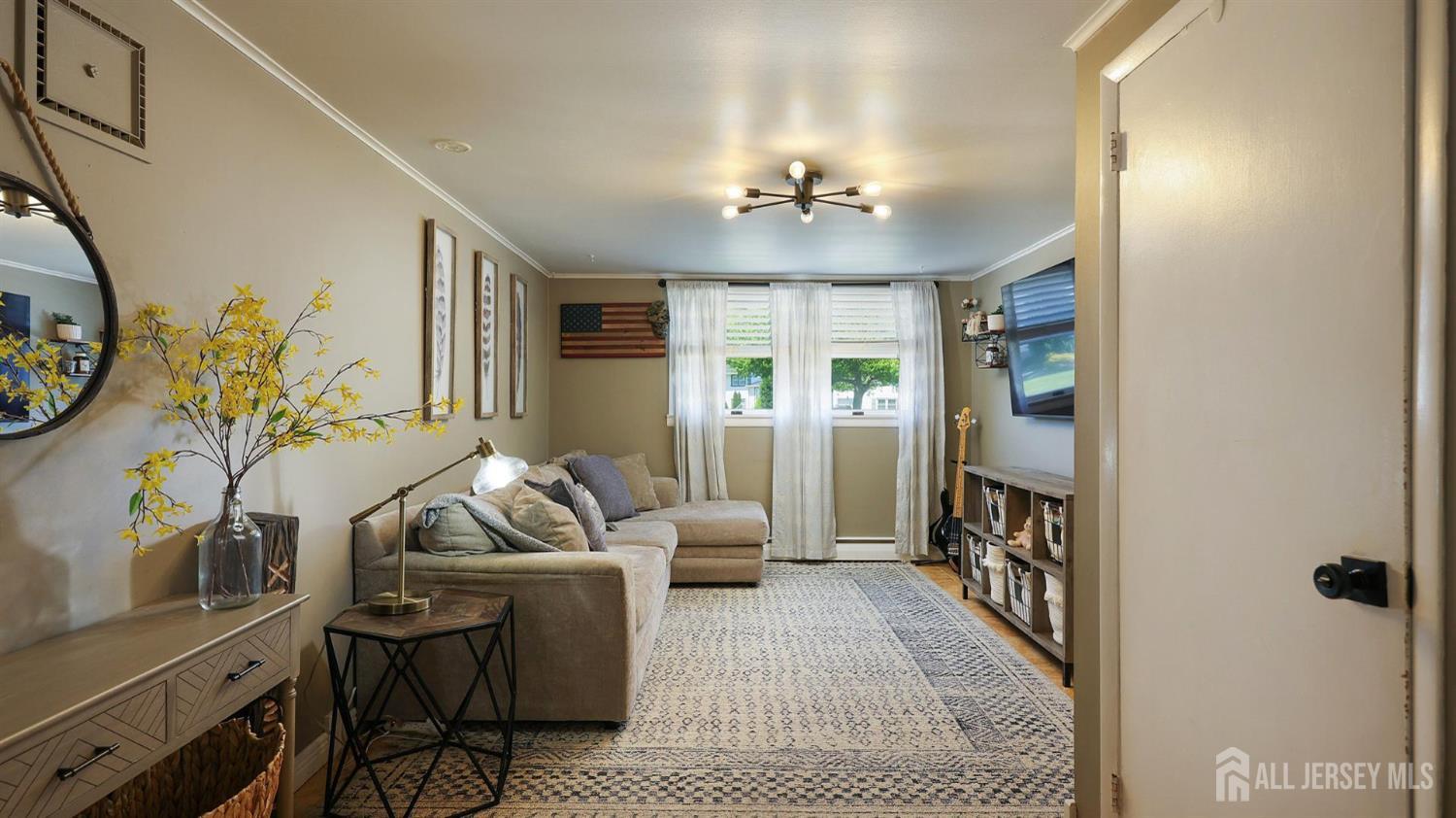 47 Miliken Road Colonia, NJ 07067 - Photo 22 of 40 a living room with furniture and wooden floor