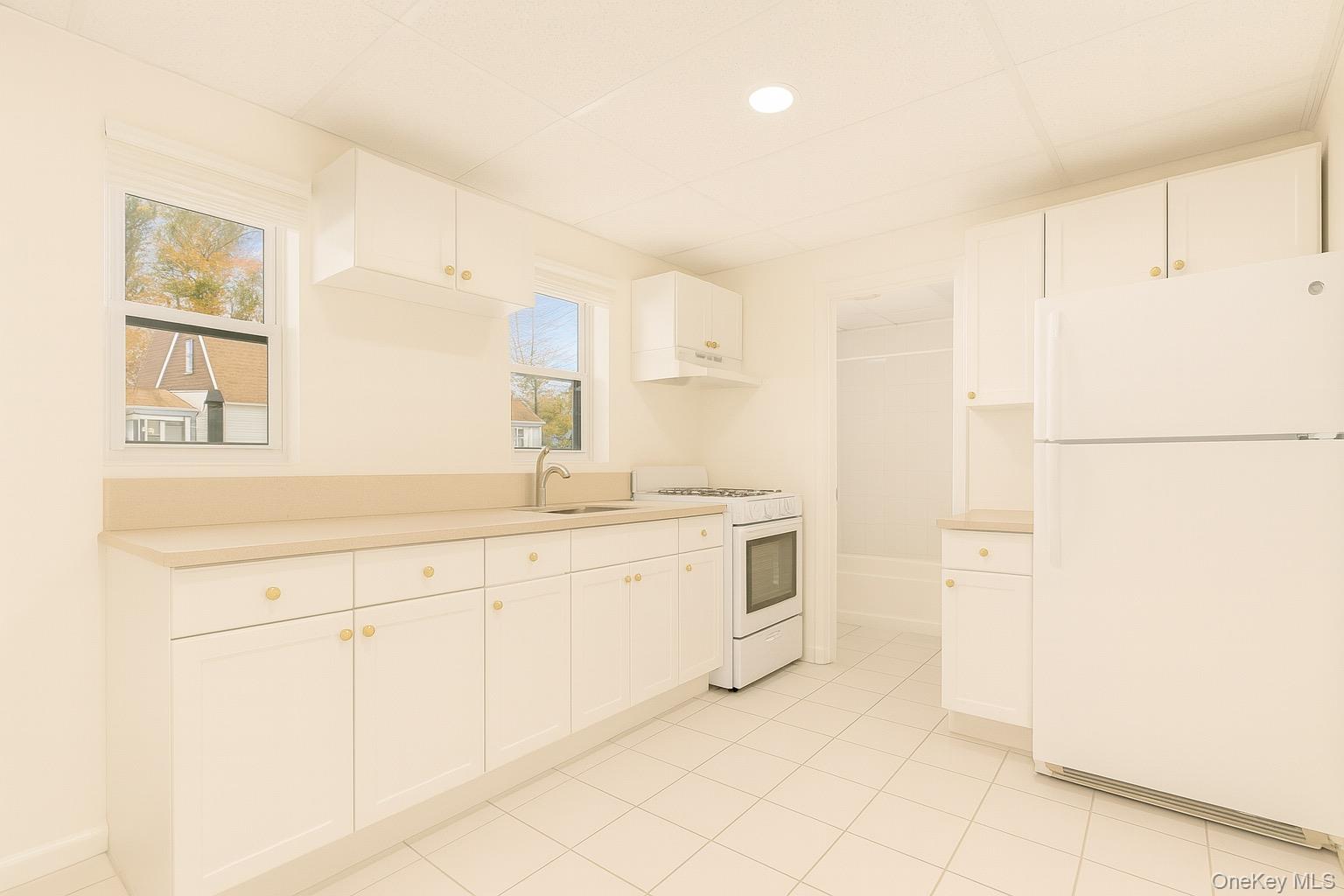 174 Mills Pond Road, Unit B St. James, NY 11780 - Photo 2 of 4 a spacious bathroom with a sink and a mirror