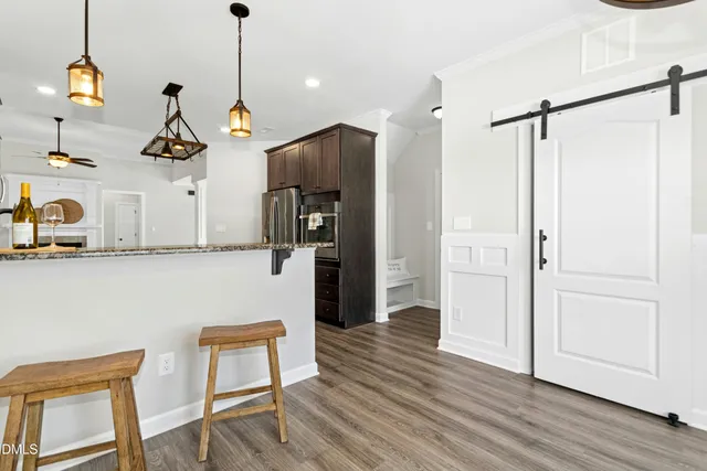 a room with wooden floor and windows