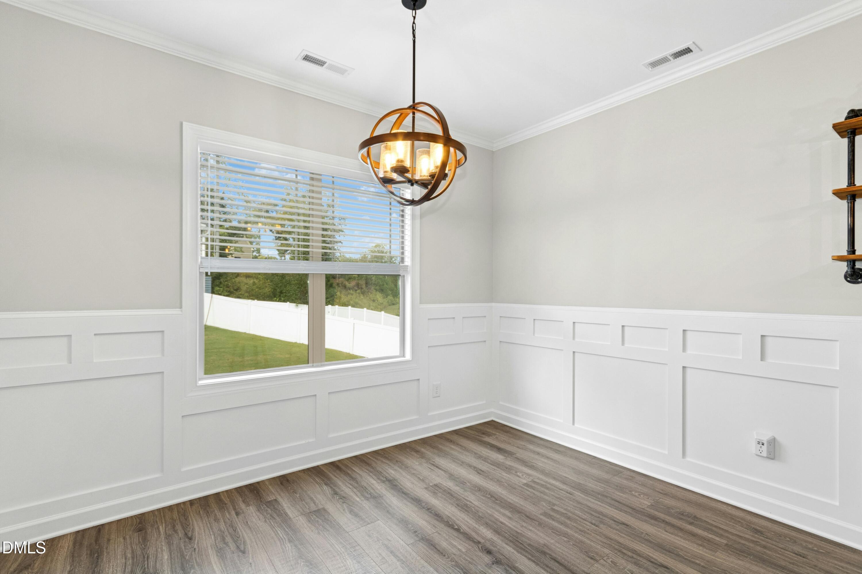 165 Thunder Ridge Drive Garner, NC 27529 - Photo 13 of 32 a view of an empty room with a window and wooden floor