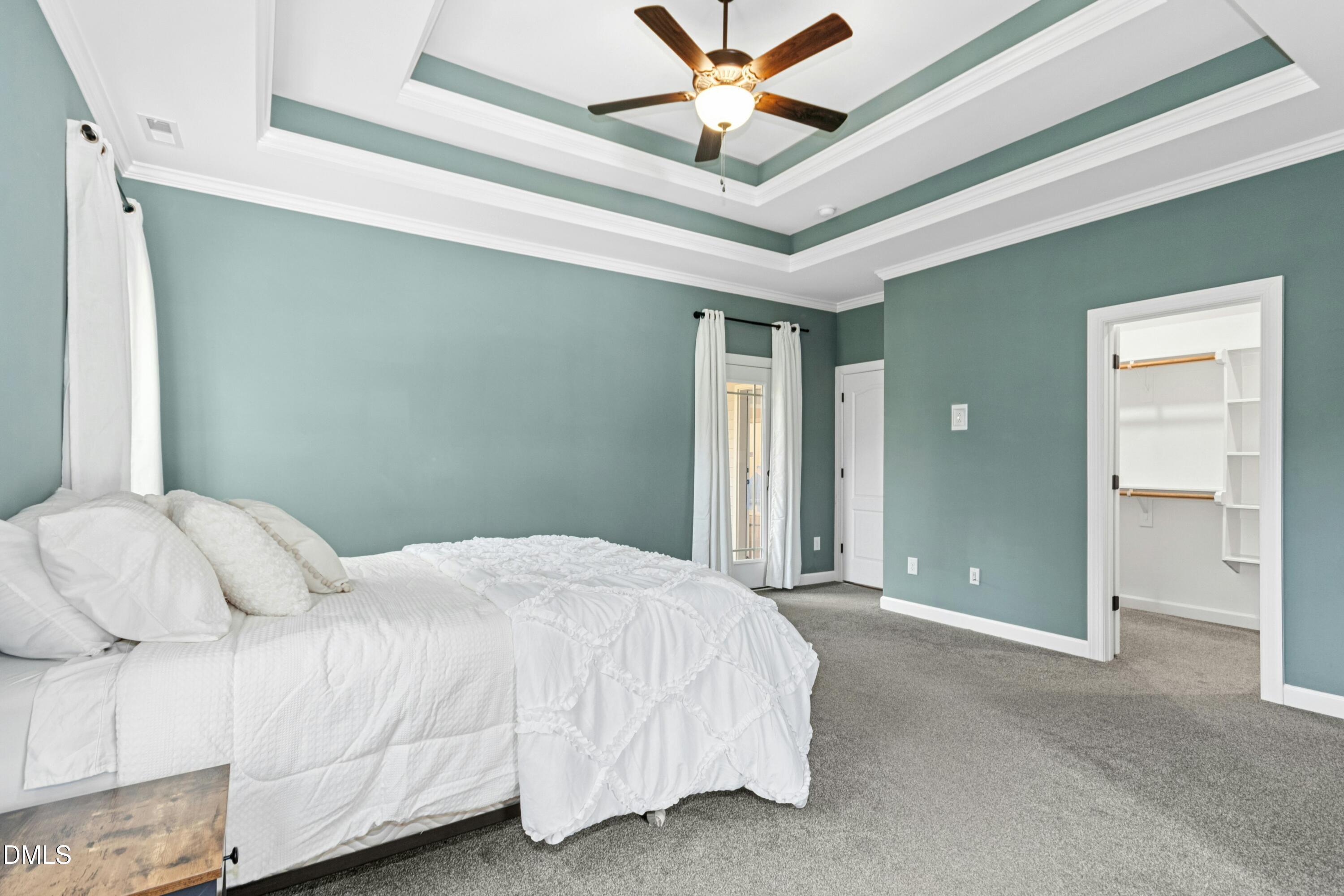 165 Thunder Ridge Drive Garner, NC 27529 - Photo 16 of 32 a bedroom with a large bed chandelier and a window