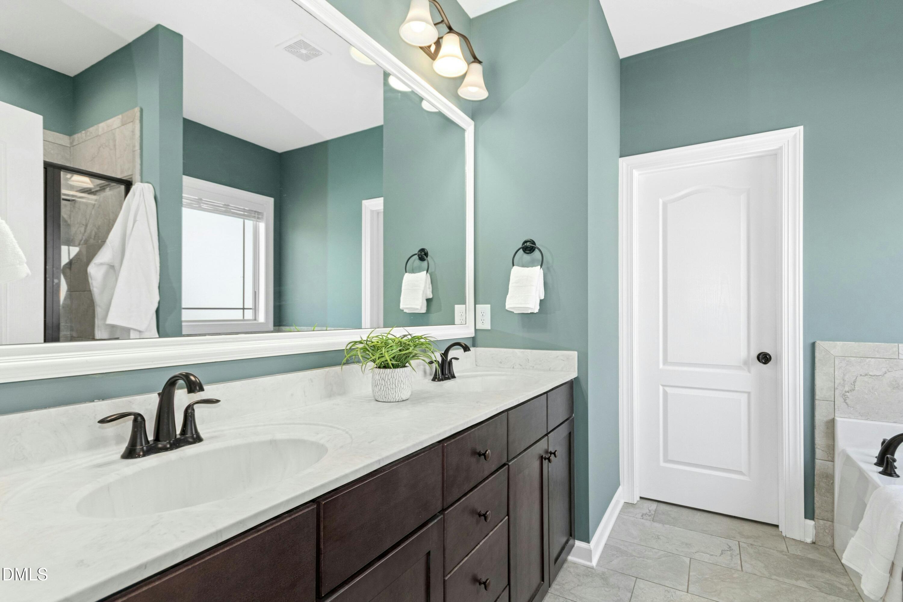 165 Thunder Ridge Drive Garner, NC 27529 - Photo 18 of 32 a bathroom with a sink and a mirror