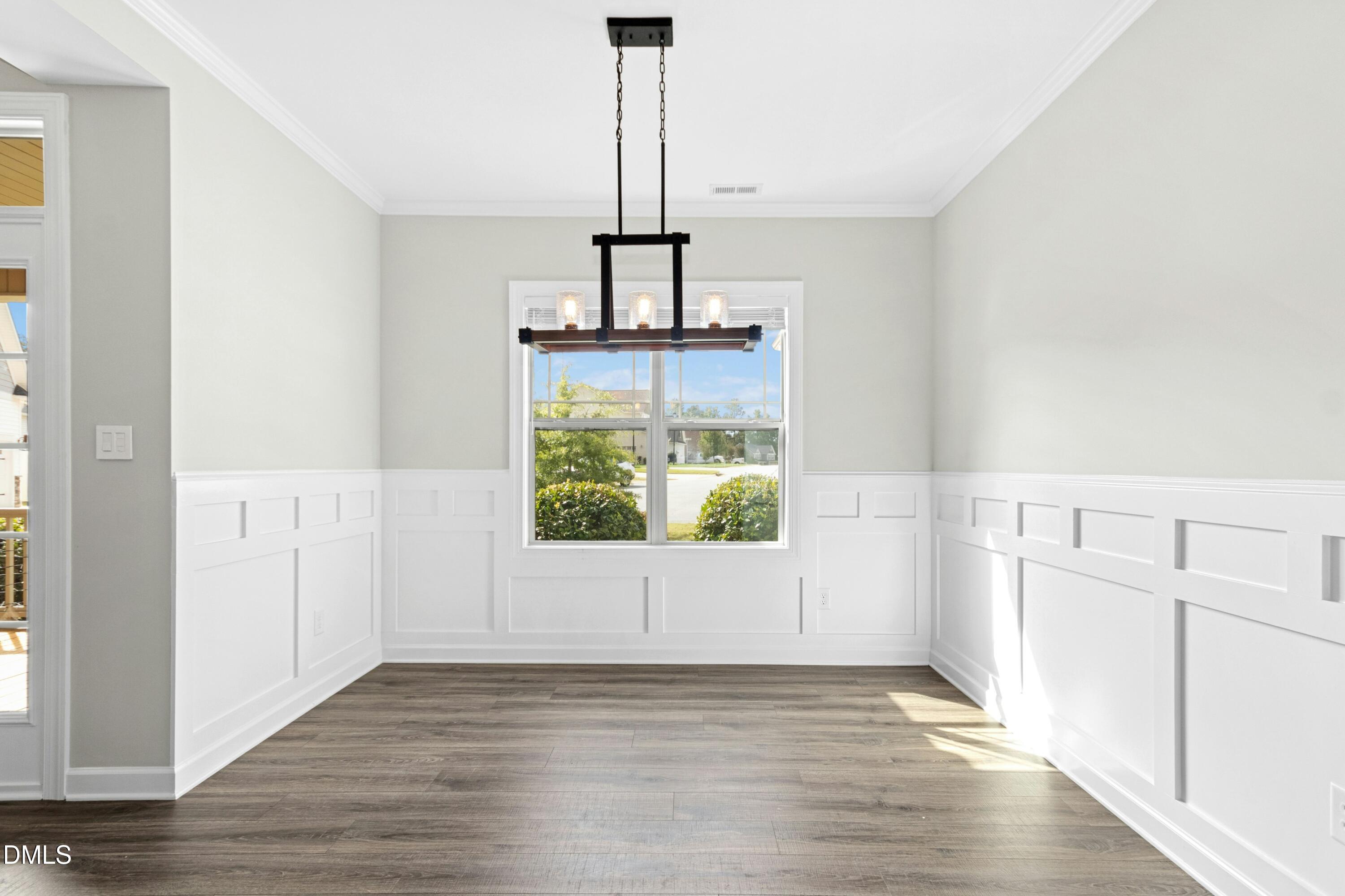 165 Thunder Ridge Drive Garner, NC 27529 - Photo 4 of 32 an empty room with wooden floor and windows