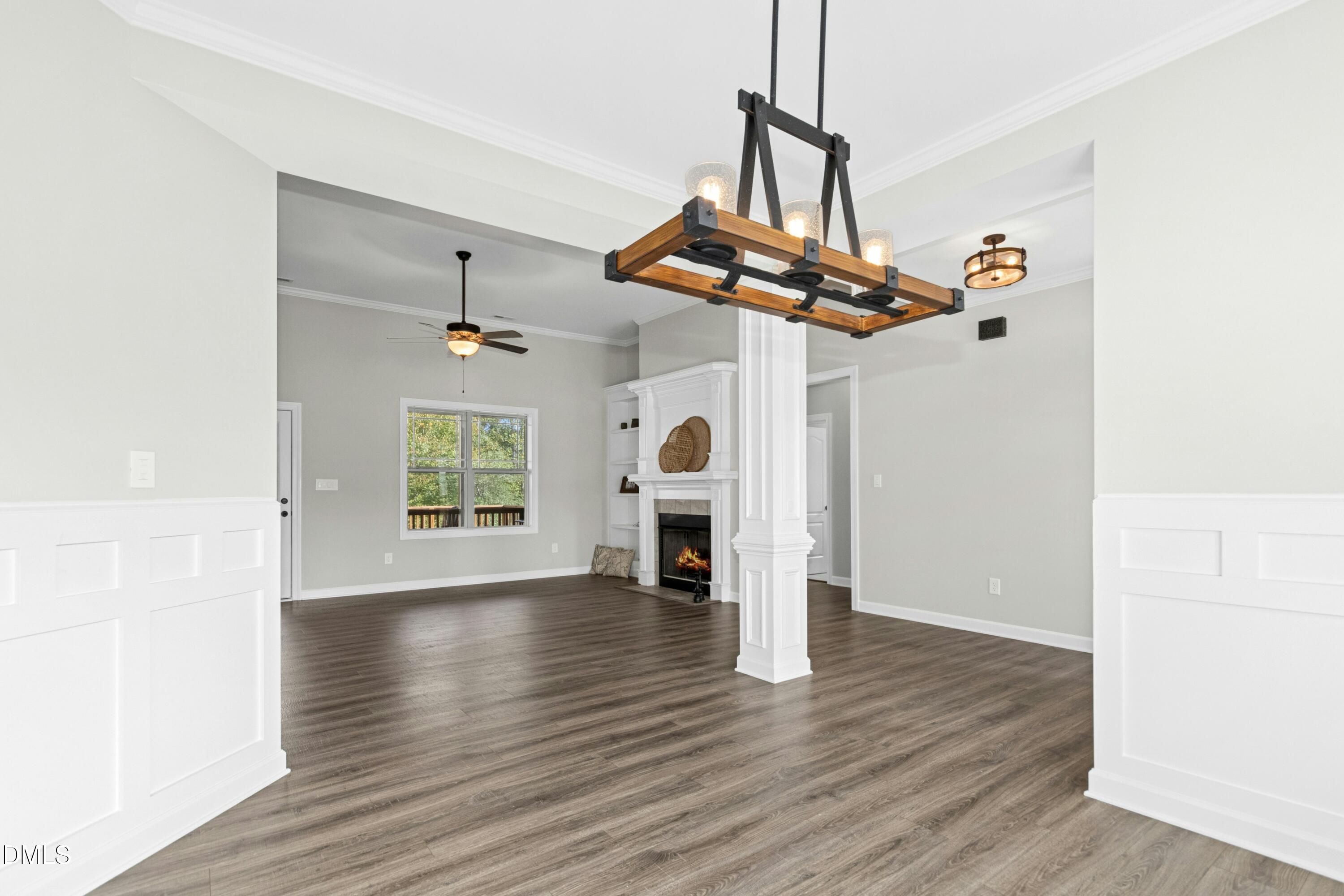 165 Thunder Ridge Drive Garner, NC 27529 - Photo 5 of 32 a view of a livingroom with wooden floor a ceiling fan and windows