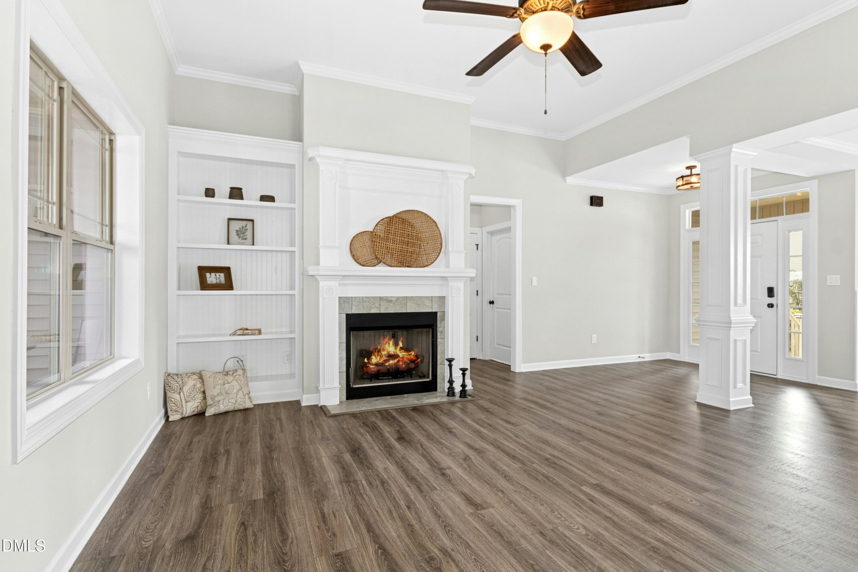 165 Thunder Ridge Drive Garner, NC 27529 - Photo 7 of 32 a view of an empty room with wooden floor fireplace and a window
