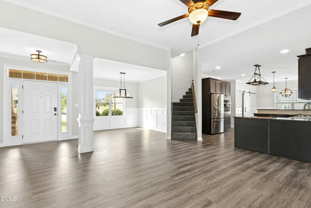 a view of a kitchen with a stove cabinets wooden floor and a ceiling fan