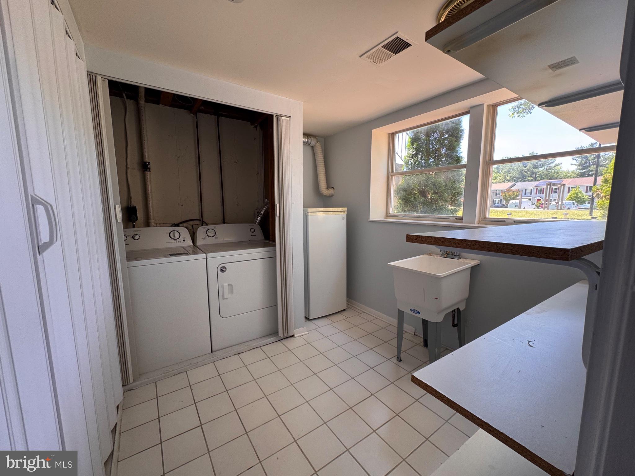 6917 Villa-Del-Rey Court Springfield, VA 22150 - Photo 21 of 26 Bright and functional laundry space.