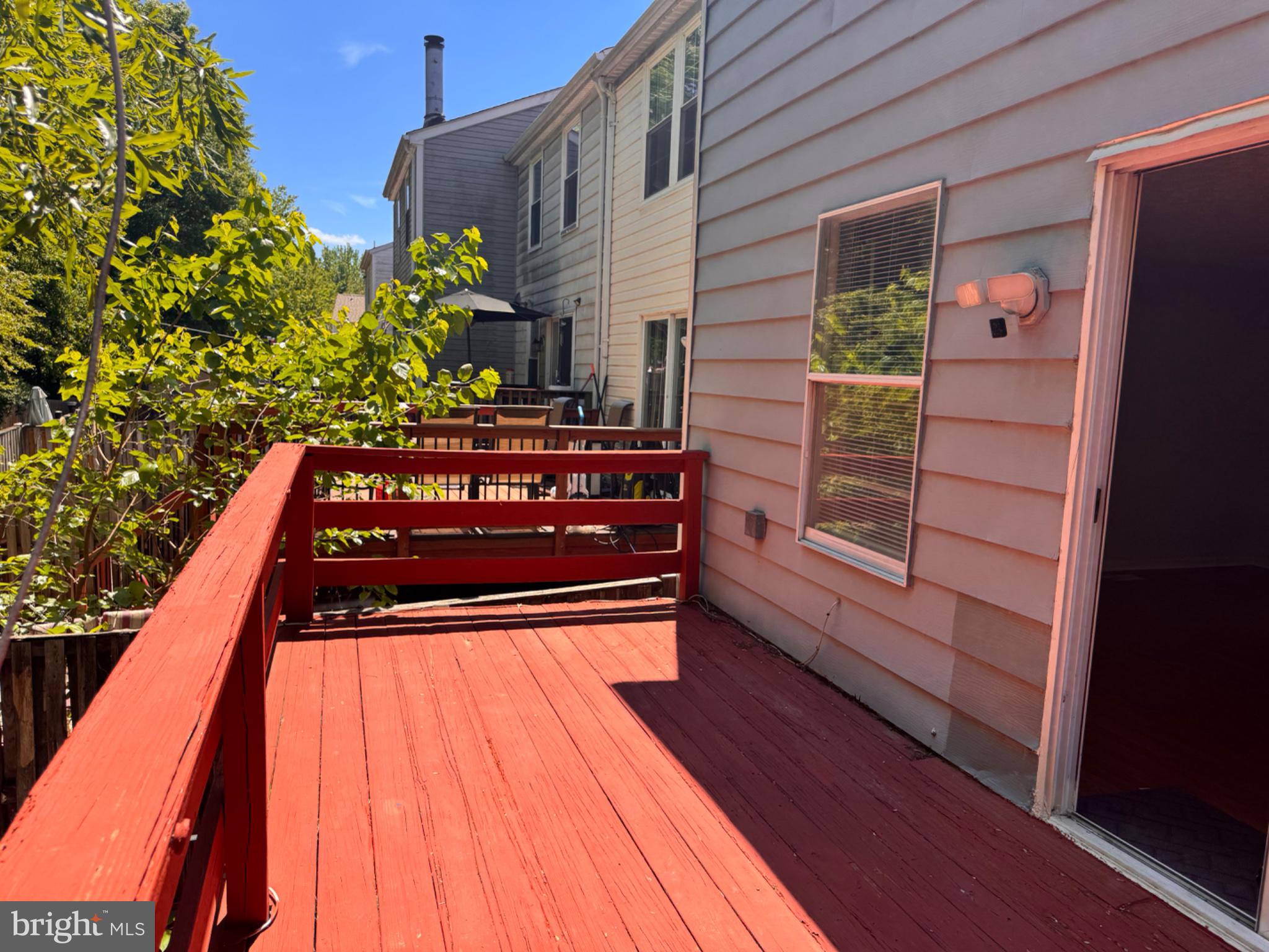 6917 Villa-Del-Rey Court Springfield, VA 22150 - Photo 25 of 26 Sunny deck with vibrant red hues.