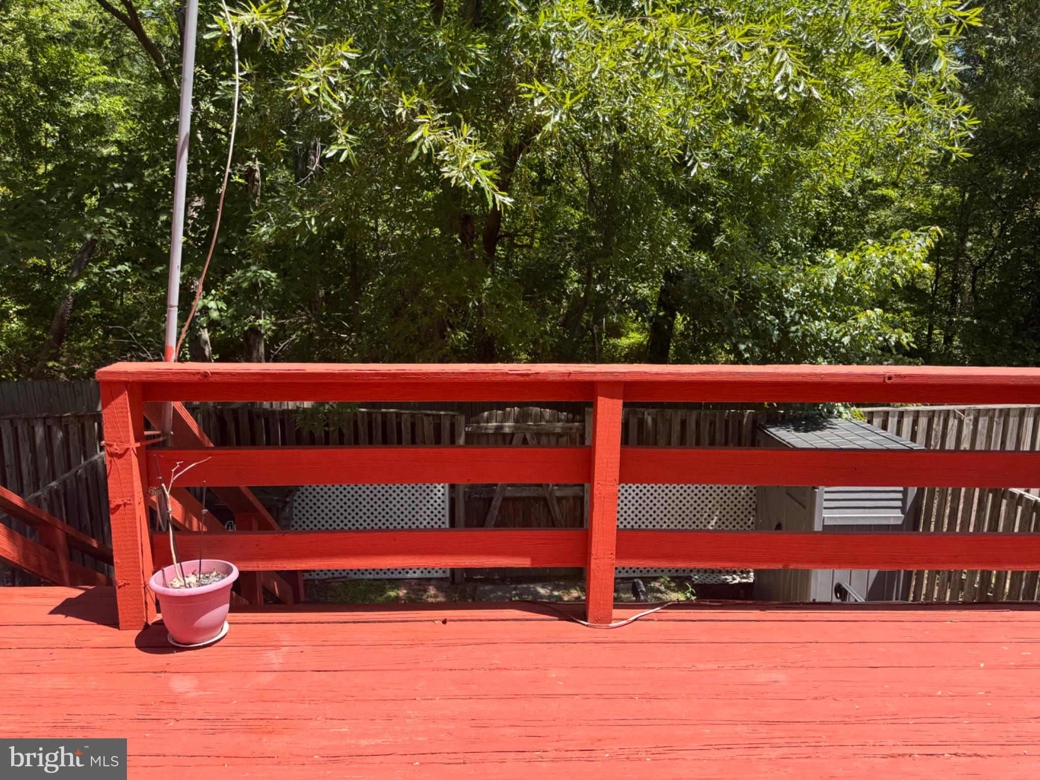 6917 Villa-Del-Rey Court Springfield, VA 22150 - Photo 26 of 26 Vibrant deck overlooking lush greenery.