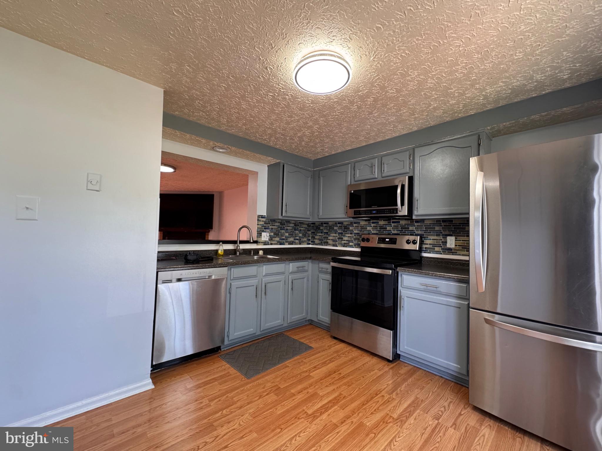 6917 Villa-Del-Rey Court Springfield, VA 22150 - Photo 3 of 26 Modern kitchen with sleek finishes.