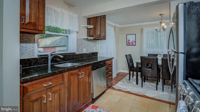 a kitchen with stainless steel appliances granite countertop a sink stove and cabinets