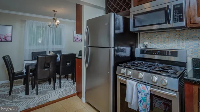 a kitchen with a stove a microwave and refrigerator