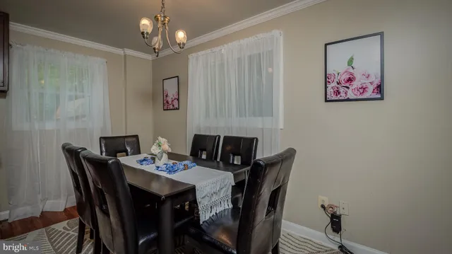 a view of a dining room with furniture wooden floor and a chandelier