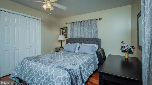 a bed sitting in a bedroom next to a window and a chandelier