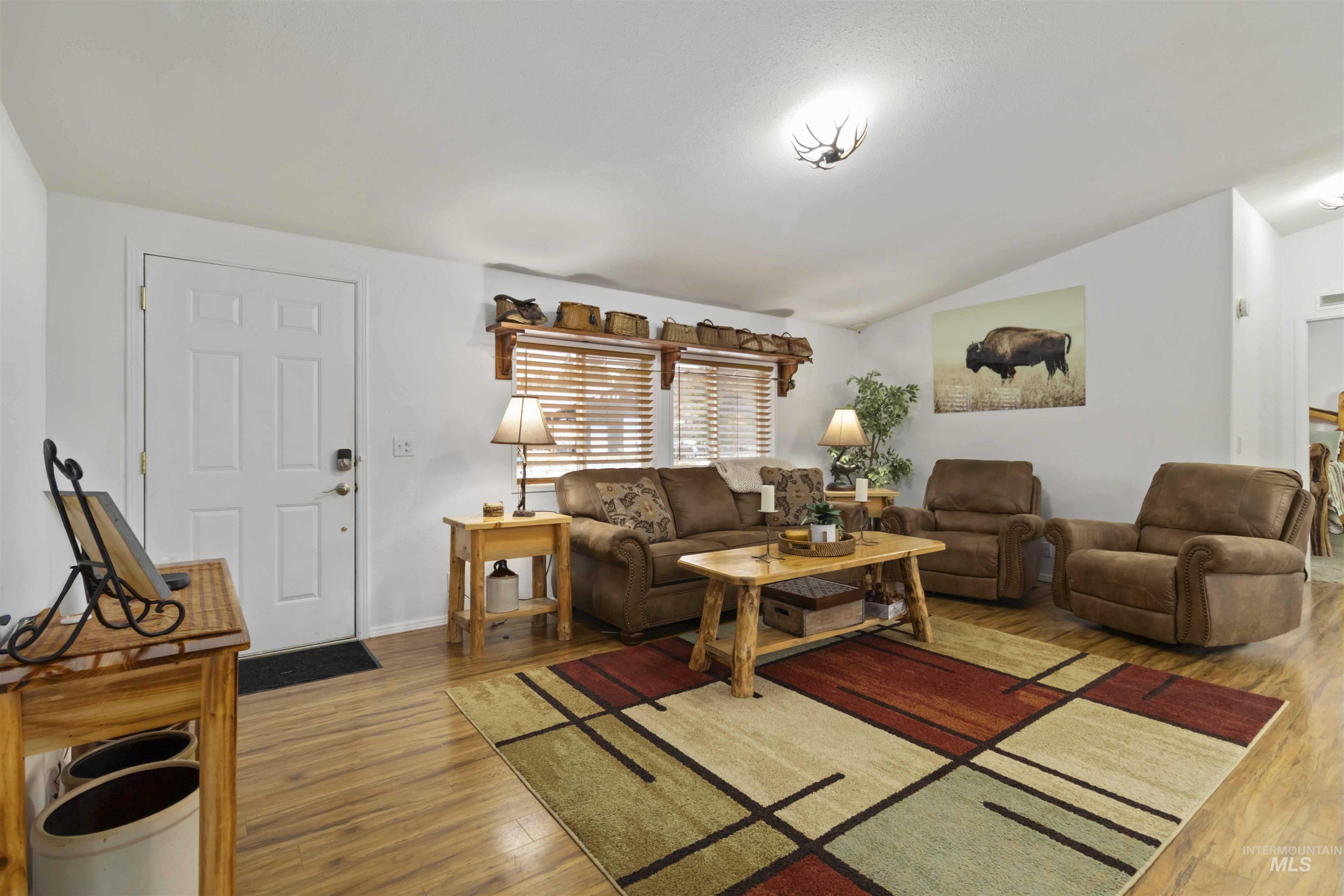 9592 Packer John Road Cascade, ID 83611 - Photo 19 of 47 Living room with vaulted ceiling and wood finished floors