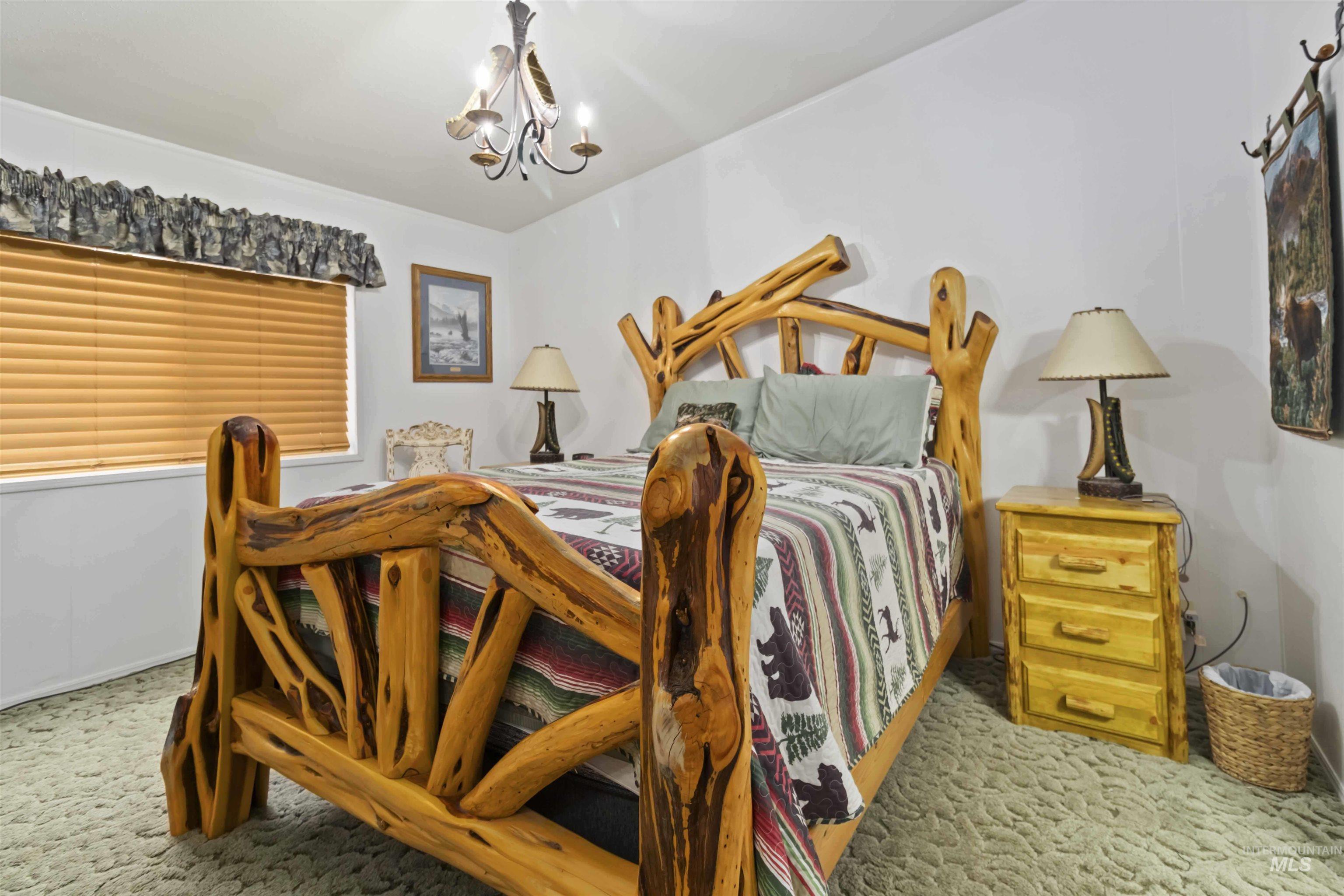 9592 Packer John Road Cascade, ID 83611 - Photo 23 of 47 Bedroom with a chandelier and carpet