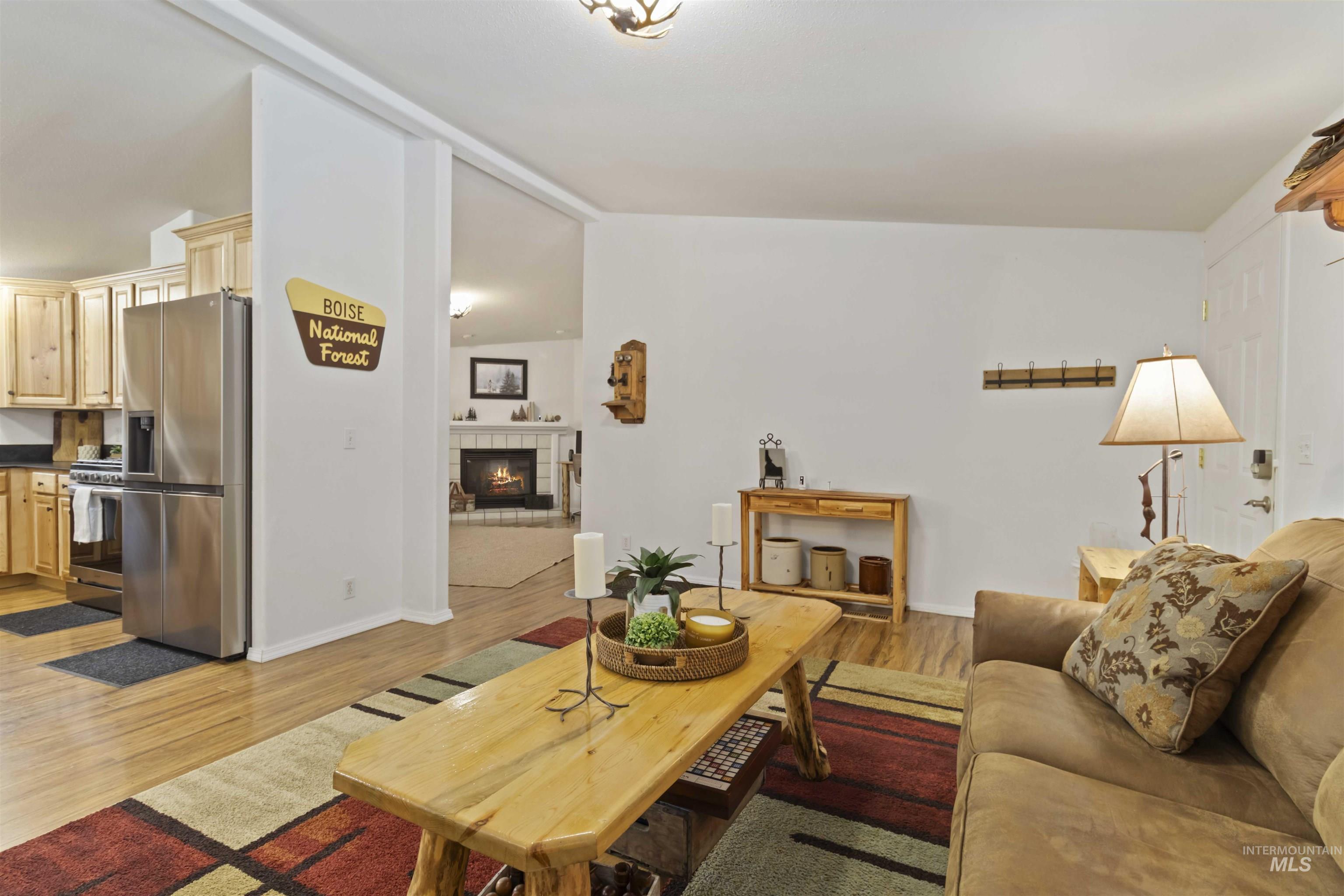 9592 Packer John Road Cascade, ID 83611 - Photo 29 of 47 Living area featuring a tile fireplace and light wood-style flooring