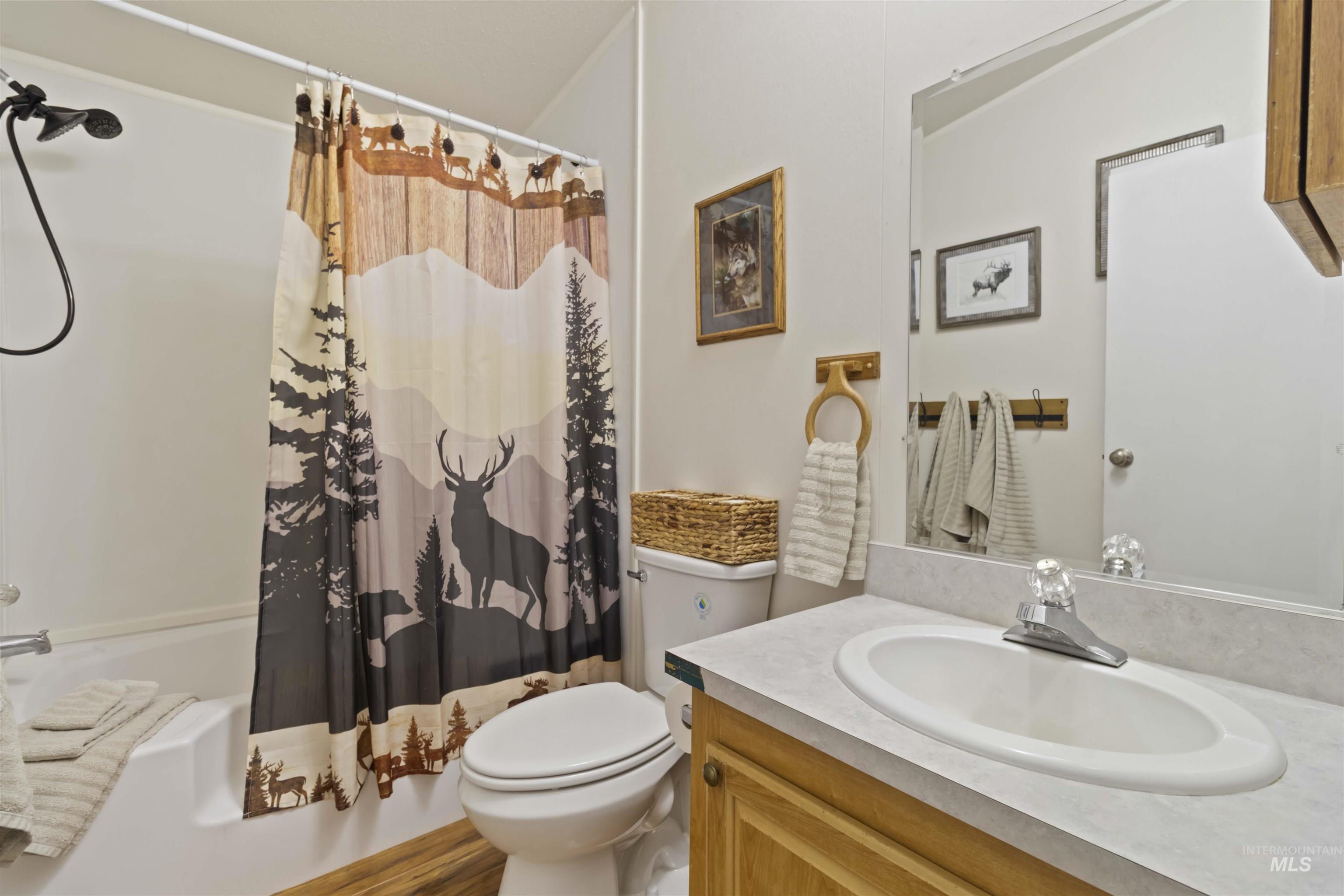 9592 Packer John Road Cascade, ID 83611 - Photo 37 of 47 Bathroom featuring shower / bath combo with shower curtain and vanity
