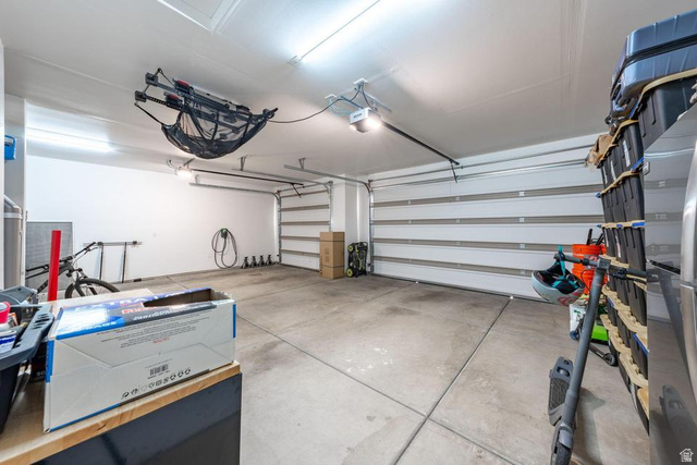 5963 Flattop Drive St. George, UT 84790 - Photo 44 of 45 Spacious garage with light-toned walls, concrete flooring, and horizontal panel garage doors