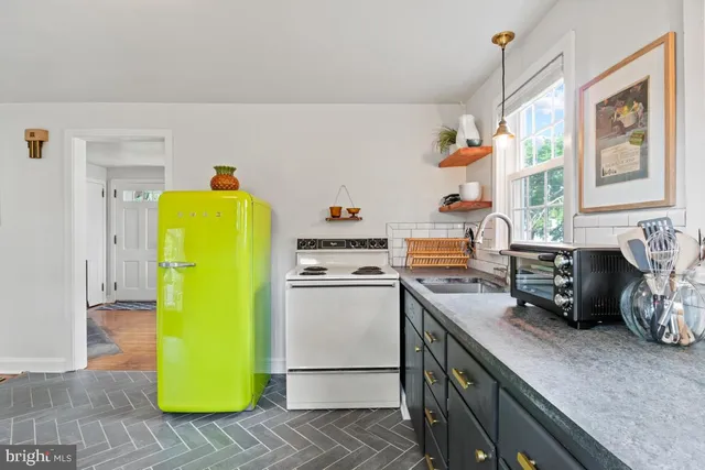 a kitchen that has a sink and a stove