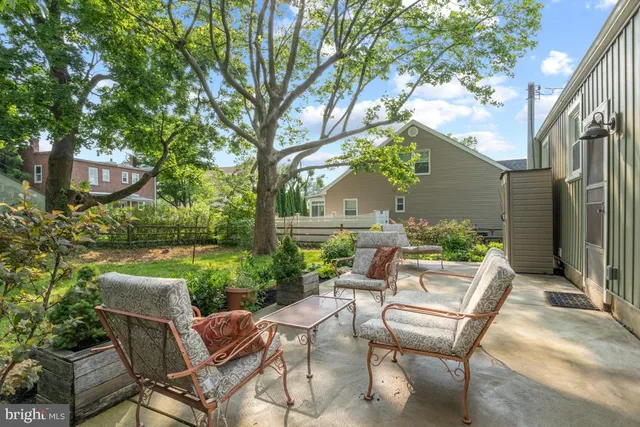 a view of backyard of house with seating space