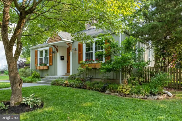 a front view of house with a garden
