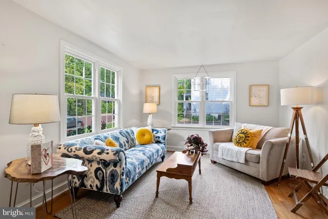 a living room with furniture and a lamp