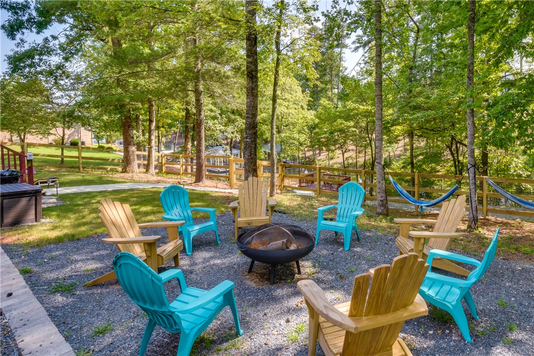 206 Petty Road Seneca, SC 29672 - Photo 41 of 48 Gather around the fire pit for outdoor entertainment, with hammocks strung among the trees for relaxation.