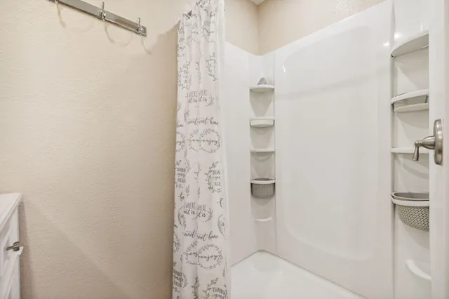 a large bed in a spacious bedroom and a bed