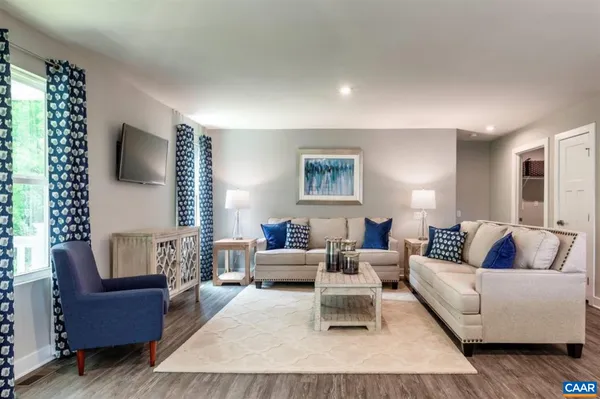 a living room with furniture and a large window