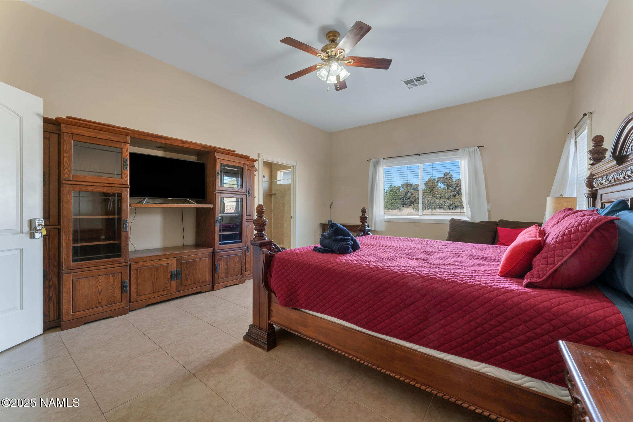 8752 South Lariat Road Williams, AZ 86046 - Photo 13 of 38 a bedroom with a bed and a flat screen tv