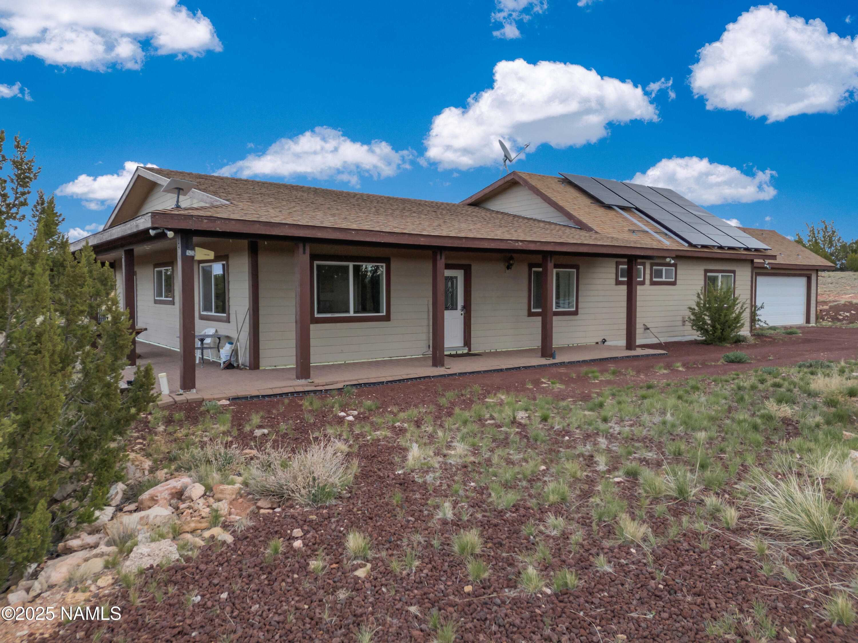 8752 South Lariat Road Williams, AZ 86046 - Photo 22 of 38 a view of a white house with a yard
