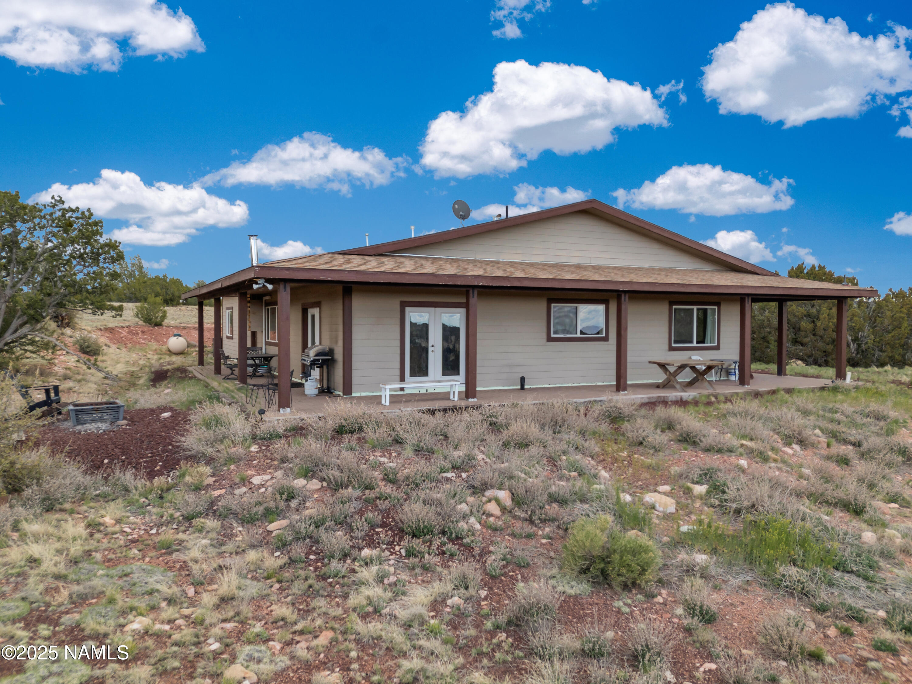 8752 South Lariat Road Williams, AZ 86046 - Photo 23 of 38 a view of a house with a backyard