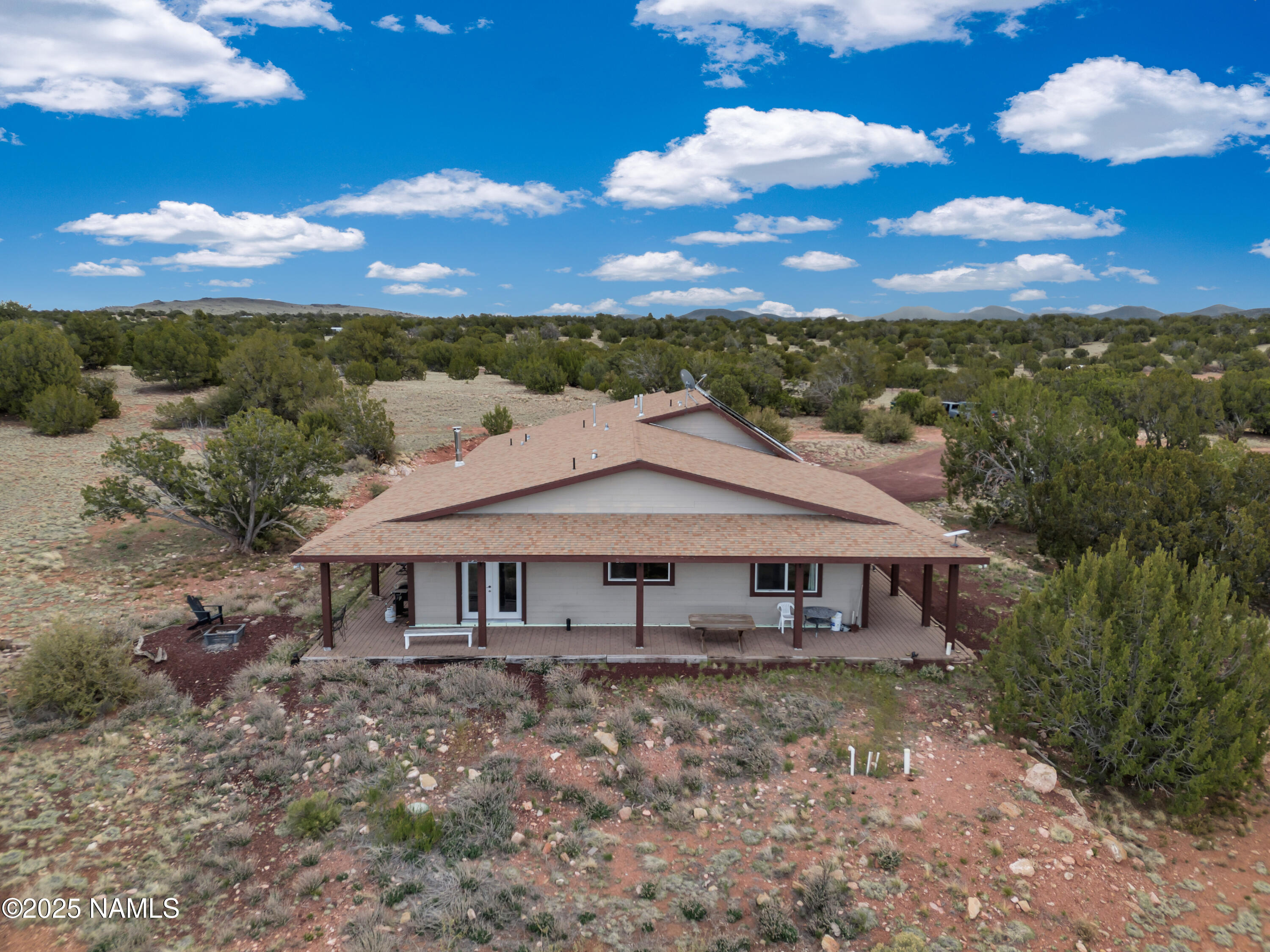 8752 South Lariat Road Williams, AZ 86046 - Photo 24 of 38 a view of a house with a big yard and large tree