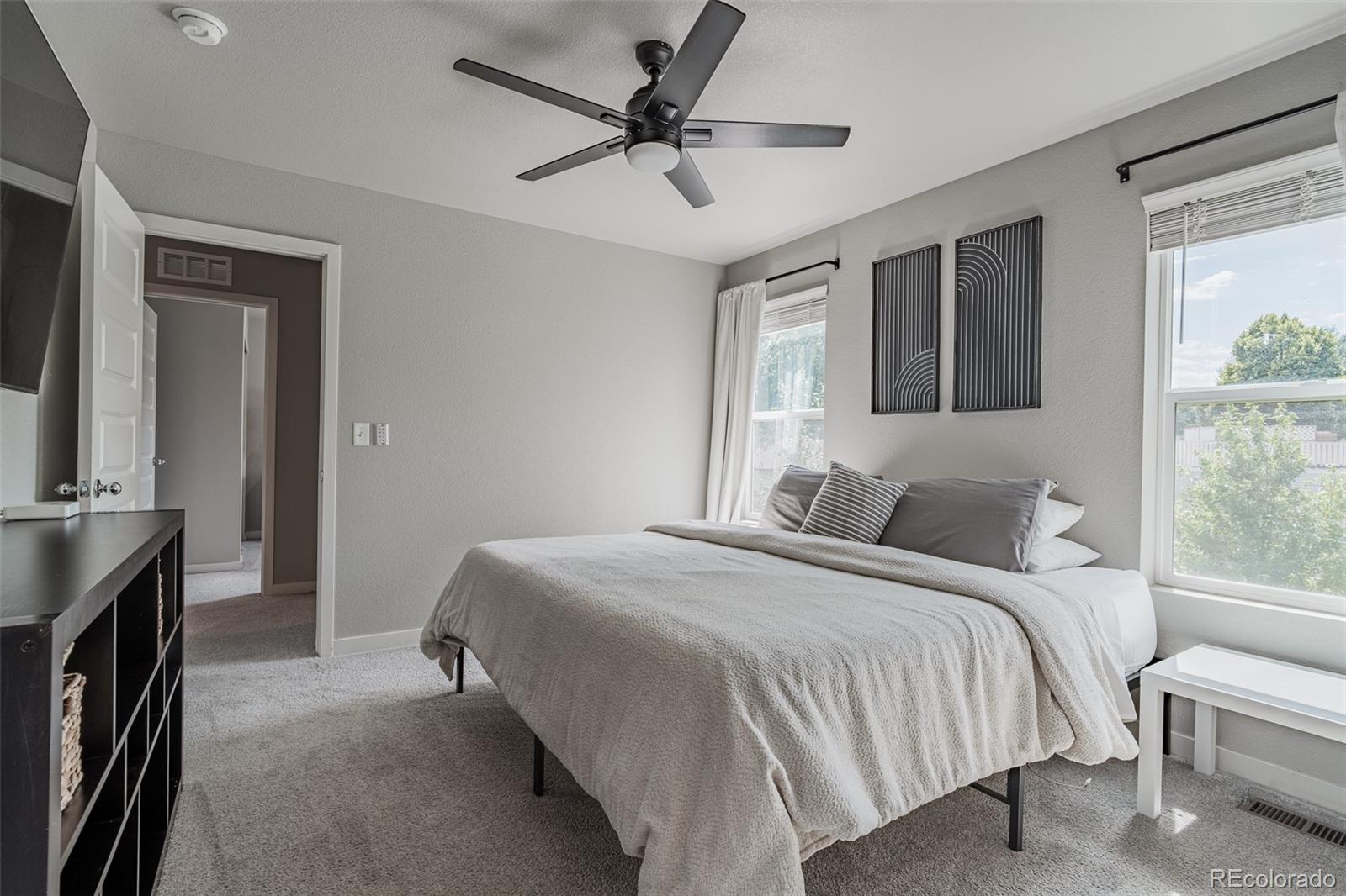 3301 Sandy Harbor Drive Evans, CO 80620 - Photo 15 of 27 a bedroom with a bed chandelier and a window