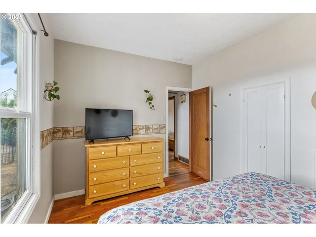 a bedroom with a bed and flat screen tv