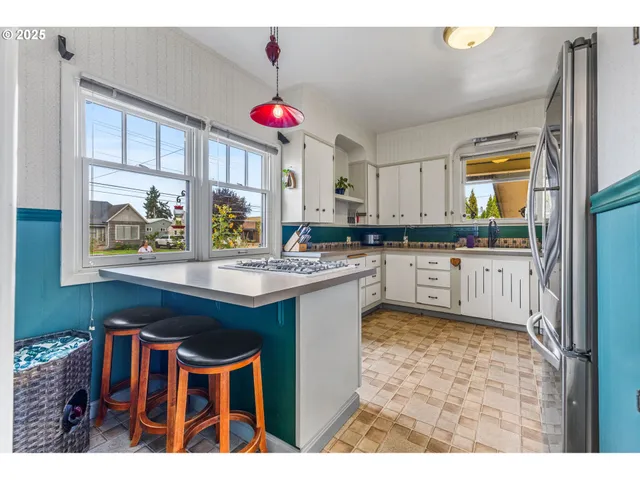 a kitchen with a sink cabinets and window