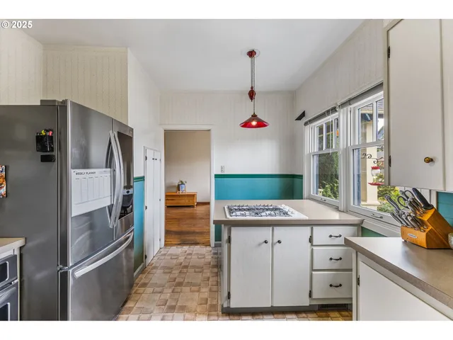 a kitchen with stainless steel appliances granite countertop a sink and a refrigerator
