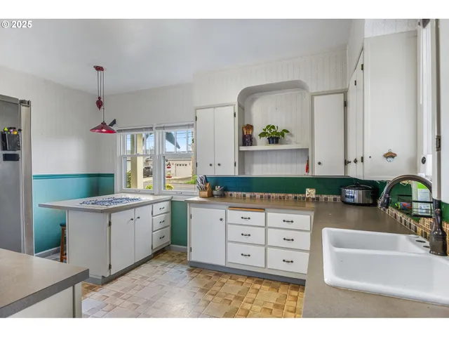 a kitchen with stainless steel appliances a sink stove and cabinets