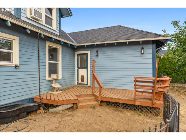 a backyard of a house with table and chairs