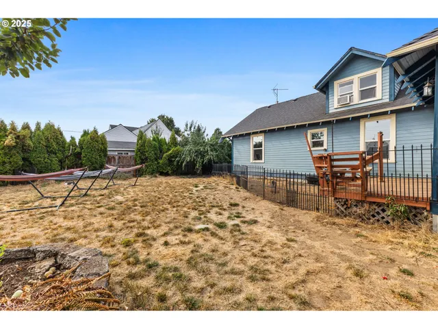 a view of a chairs and table in the backyard