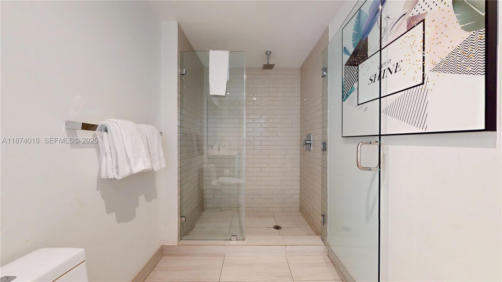 4010 South Ocean Drive, Unit R1004 Hollywood, FL 33019 - Photo 12 of 24 a bathroom with a shower and toilet
