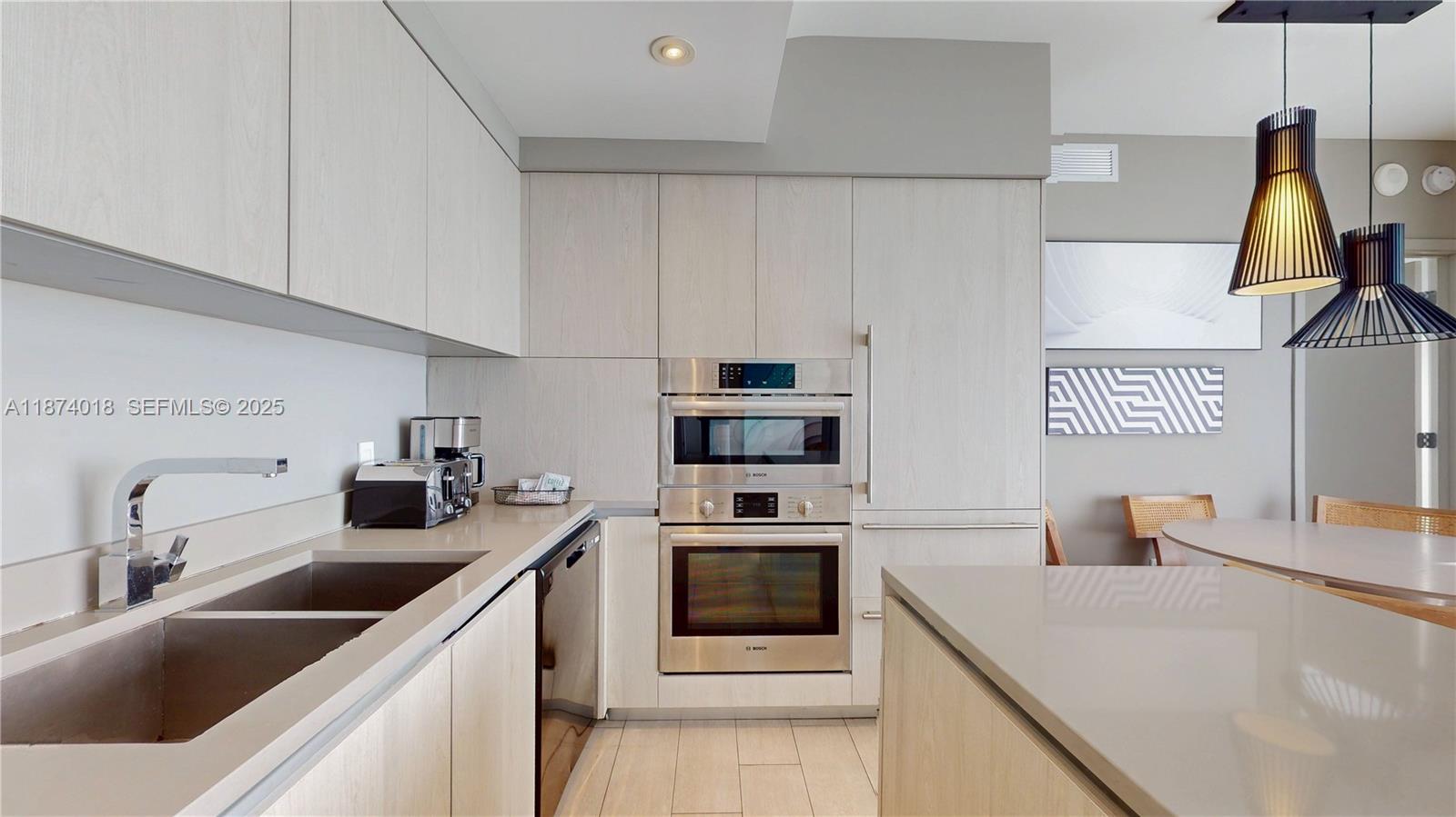4010 South Ocean Drive, Unit R1004 Hollywood, FL 33019 - Photo 2 of 24 a kitchen with stainless steel appliances a sink a stove and a refrigerator